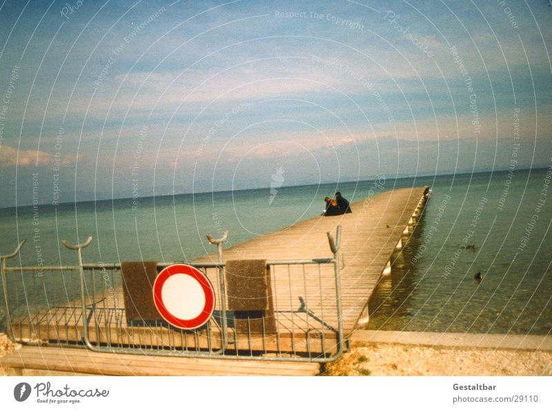 Forbidden! Lake Lake Garda Beach Footbridge Wood Bans Fence Calm Loneliness Italy Cold Formulated Europe Water Sit Human being Graffiti Sky