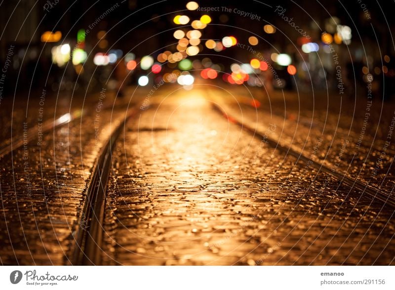 Lights of the street Sightseeing City trip Town Downtown Old town Deserted Transport Street Rail transport Tram Stone Illuminate Dark Wet Yellow Loneliness