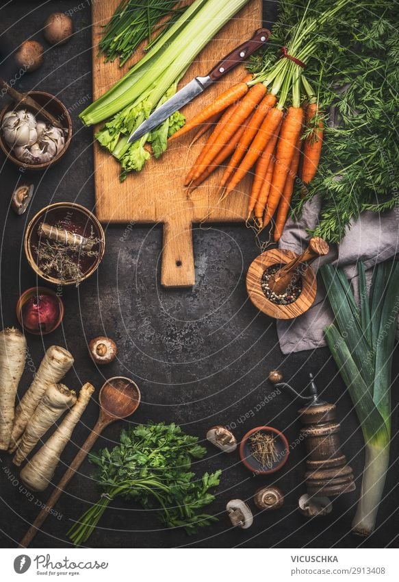 Various fresh vegetables on kitchen table with wooden spoon and cutting board. Healthy cooking at home various healthy