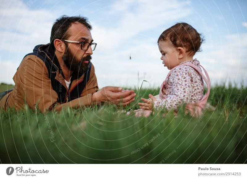 Father showing grasshopper jumping Lifestyle Vacation & Travel Tourism Adventure Camping Parenting Human being Child Toddler Girl Man Adults 1 - 3 years