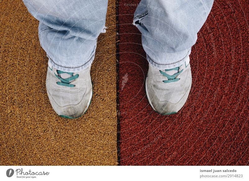 feet on the colorful ground in the playground Feet body part Human being Legs Sneakers Footwear Sports Sports top Lifestyle Stand Ground Multicoloured Street