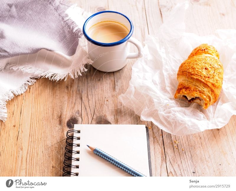 Coffee break with croissant Food Dough Baked goods Croissant Nutrition Breakfast To have a coffee Beverage Hot drink Mug Stationery Paper Piece of paper Pen