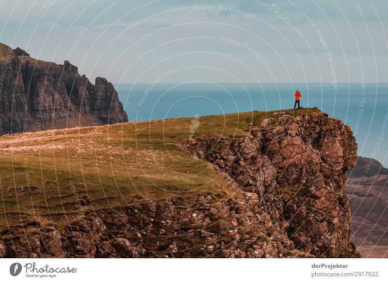 A photographer takes a picture of the view on Isle of Skye III Nature Environment Hiking Vacation & Travel Mountain Sea coast hike hiking trail Quiraing