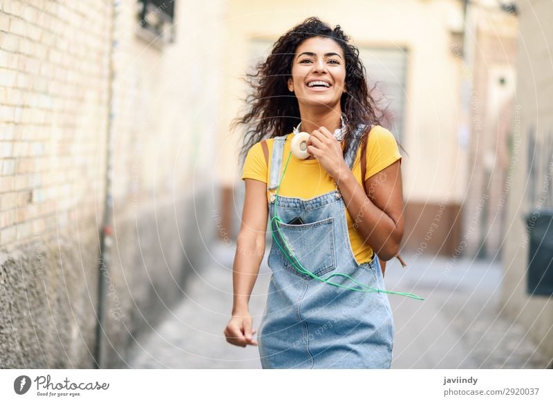 Young African woman with headphones walking outdoors Lifestyle Style Joy Happy Beautiful Hair and hairstyles Human being Feminine Young woman