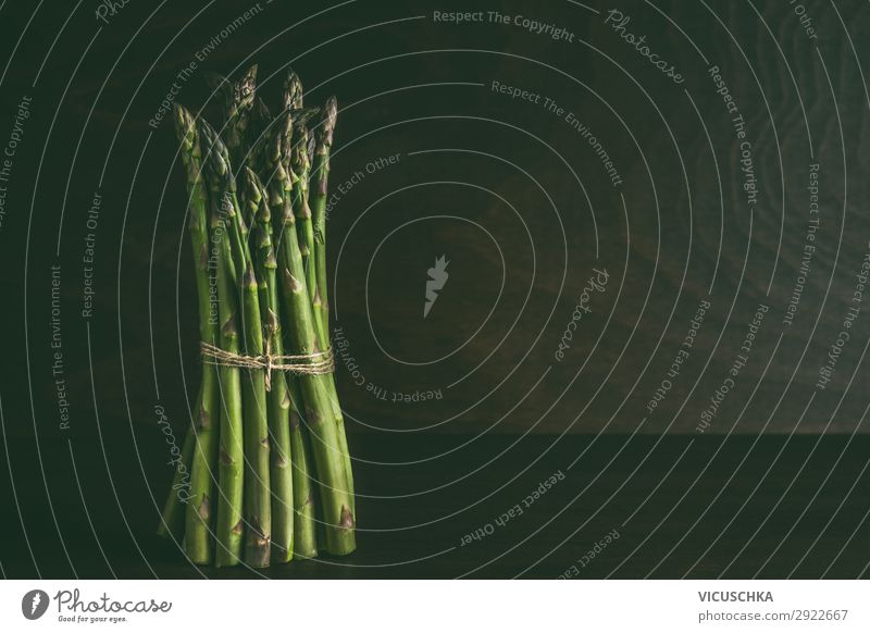 Asparagus bundles standing on a dark table Food Vegetable Nutrition Organic produce Vegetarian diet Diet Shopping Design Healthy Eating Wall (barrier)