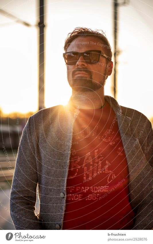 Man with sunglasses, waiting at the station. Adults Face 1 Human being 30 - 45 years Sunrise Sunset Sunlight Industrial plant Train station Looking Stand Wait