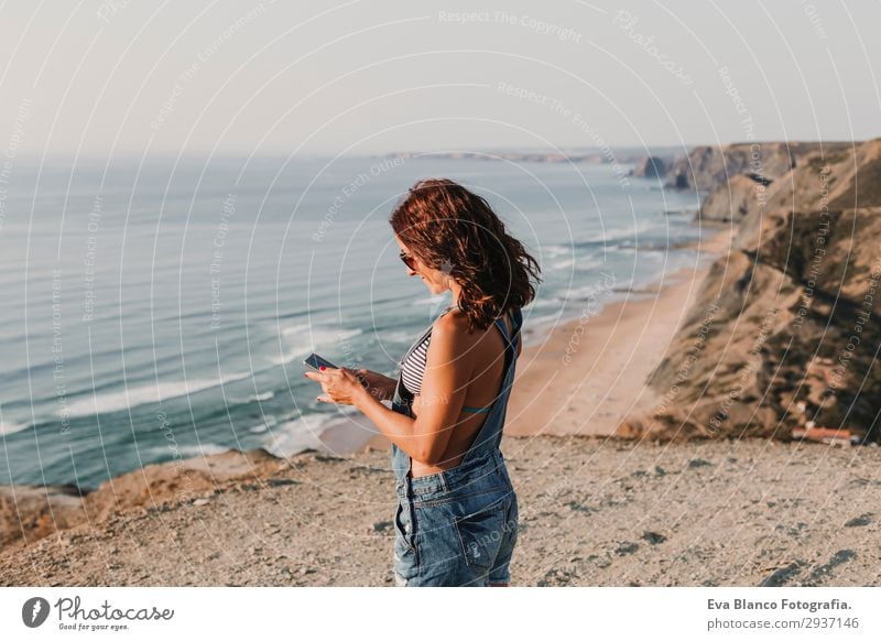 portrait of beautiful happy young woman outdoors Lifestyle Happy Beautiful Relaxation Vacation & Travel Summer Sunbathing Beach Ocean To talk Telephone