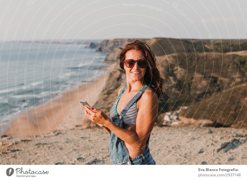 portrait of beautiful happy young woman outdoors Lifestyle Happy Beautiful Relaxation Vacation & Travel Summer Sunbathing Beach Ocean To talk Telephone