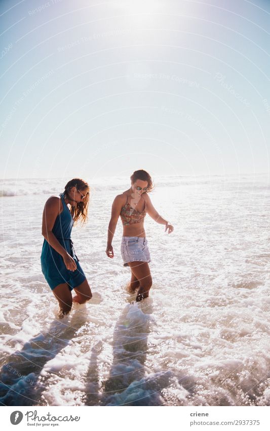 Happy Friends walking on the beach close to ocean Joy Leisure and hobbies Vacation & Travel Summer Ocean Waves Woman Adults Friendship Smiling Together water