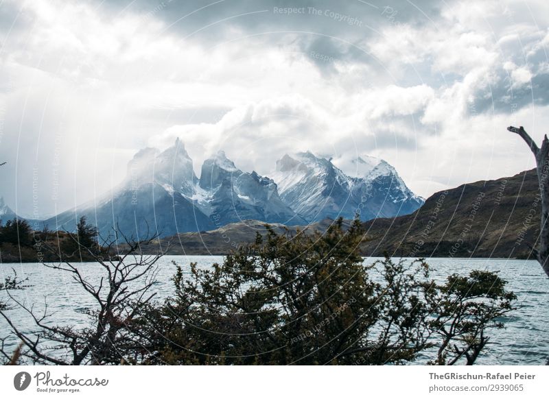 Cerro Paine Grande Environment Nature Landscape Blue Gray Black White Water Lake lago péhoe Torres del Paine NP Mountain Vantage point Tourism Clouds Dramatic