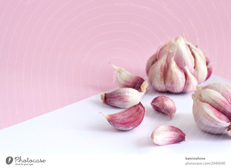 Fresh garlic on a light pink background Vegetable Herbs and spices Vegetarian diet White Decline Garlic bulb ingrerient Clove pastel food health healthy Organic