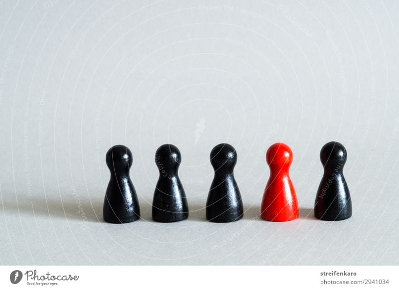 Red game piece in a row of black game pieces Playing School Team Group Toys Wood Together Uniqueness Black Success Force Brave Acceptance Trust Safety Agreed