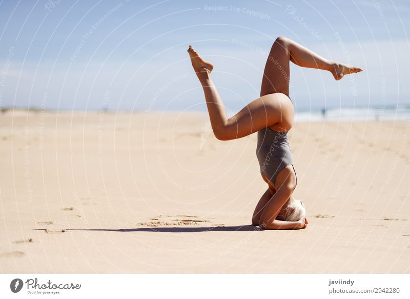 Caucasian woman practicing yoga at seashore. Lifestyle Beautiful Body Harmonious Relaxation Meditation Summer Beach Ocean Sports Yoga Human being Feminine