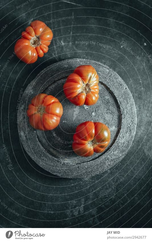 Fresh red Marmande RAF red tomatoes on concrete dish. Vegetable Fruit Vegetarian diet Diet Plate Garden Table Nature Natural Clean Green Red Colour Tomato