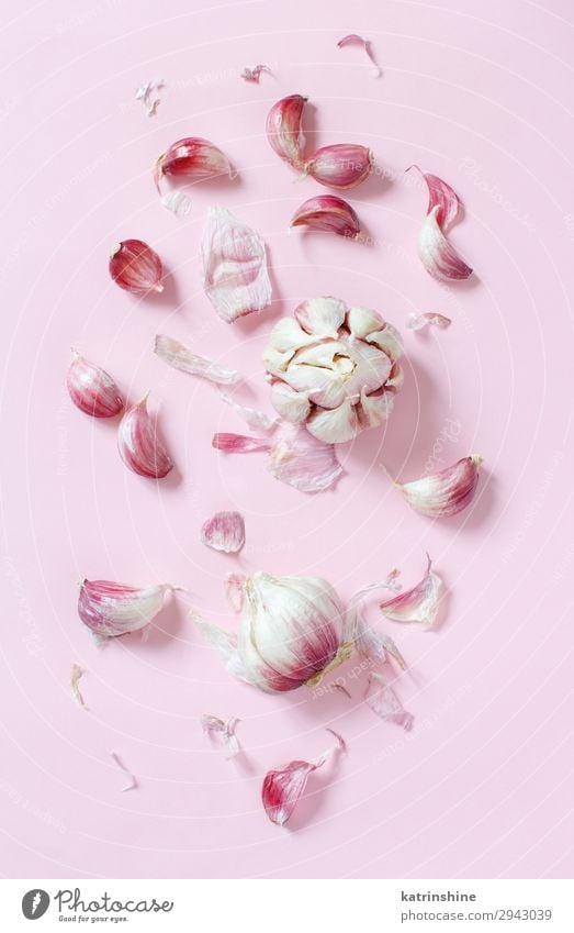 Fresh garlic on a light pink background Vegetable Herbs and spices Vegetarian diet Above Decline Garlic bulb ingrerient Clove pastel food health healthy Organic