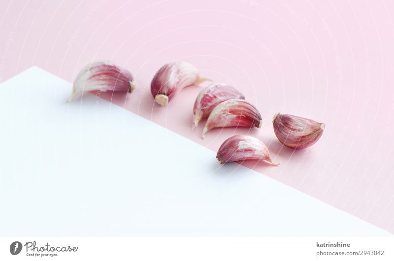 Fresh garlic on a light pink background Vegetable Herbs and spices Vegetarian diet White Decline Garlic bulb ingrerient Clove pastel food health healthy Organic