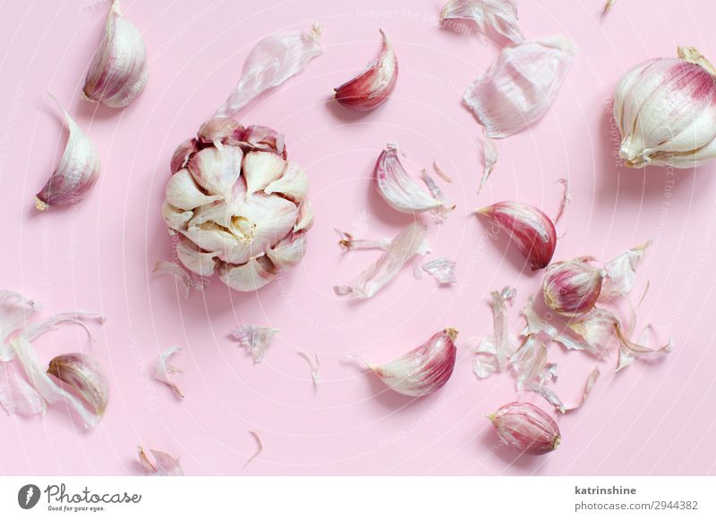 Fresh garlic on a light pink background Vegetable Herbs and spices Vegetarian diet Above Decline Garlic bulb ingrerient Clove pastel food health healthy Organic