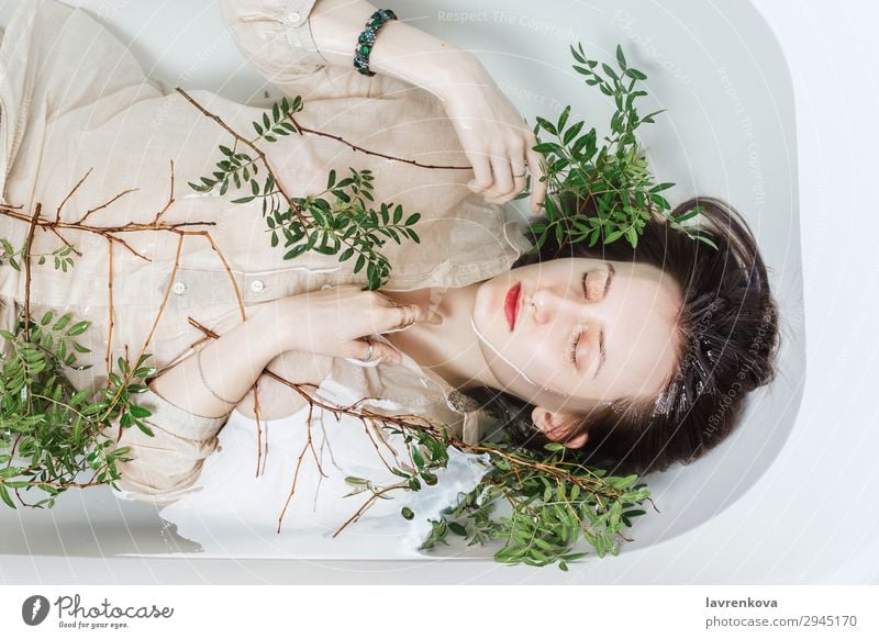 Female lying in bathtub with pistachio branches Tub Attractive Swimming & Bathing Bathroom Bathtub Beautiful Branch Personal hygiene Caucasian Woman Flower