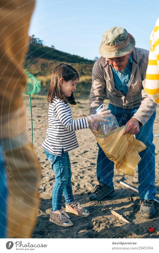 Volunteers cleaning the beach Happy Beach Child Work and employment Human being Woman Adults Man Grandfather Family & Relations Environment Sand Hat Plastic Old