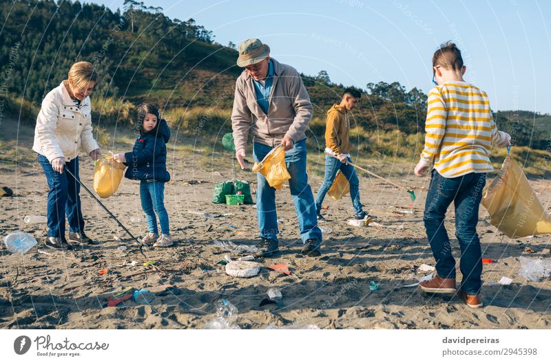 Volunteers cleaning the beach Beach Child Work and employment Human being Boy (child) Woman Adults Man Family & Relations Group Environment Old Dirty Teamwork