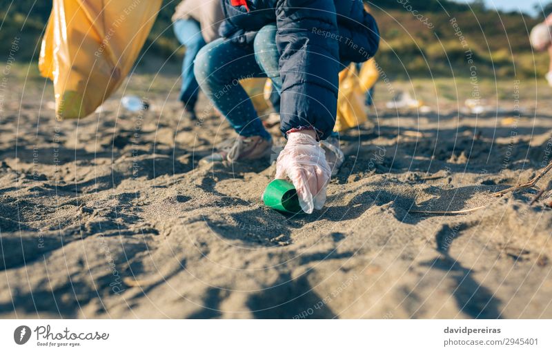 Little girl cleaning the beach Beach Child Work and employment Human being Woman Adults Family & Relations Hand Group Environment Sand Plastic Dirty Small