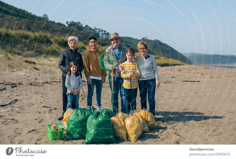 Volunteers posing after cleaning the beach Beach Child Human being Boy (child) Woman Adults Man Family & Relations Group Environment Old Smiling Pride Teamwork