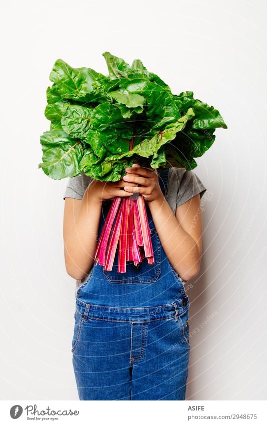 Vegan girl holding a bunch of swiss cahrd Vegetable Nutrition Vegetarian diet Diet Child Leaf Fresh Natural Green Red White chard swiss chard rainbow chard