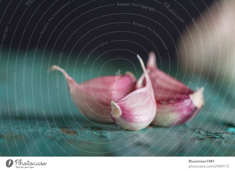 Close-up shot of fresh garlic bulbs on dark background Vegetable Nutrition Organic produce Vegetarian diet Lifestyle Healthy Eating Kitchen Group Nature Spring