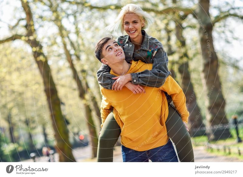 Boyfriend carrying his girlfriend on piggyback. Lifestyle Joy Happy Beautiful Leisure and hobbies Human being Masculine Feminine Young woman