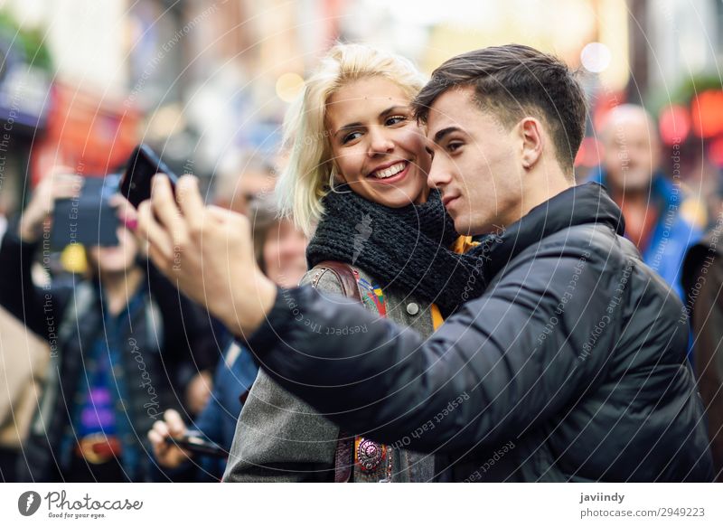 Happy couple of tourists taking selfie in a crowded street. Lifestyle Beautiful Leisure and hobbies Vacation & Travel Tourism Trip Sightseeing Human being