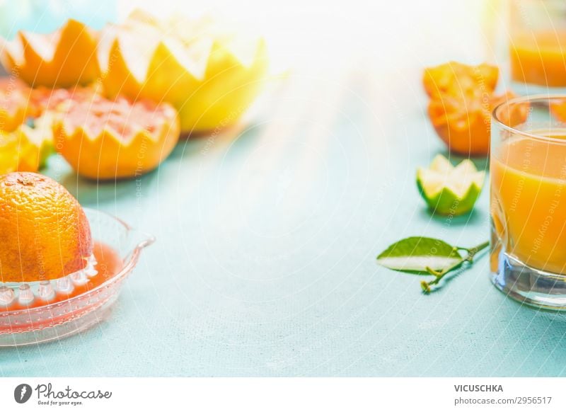 Juice of citruses. Glass with mix citruses juice on table at sunny day background.  Refreshing homemade breakfast beverages. Vitamin drink. Healthy lifestyle. Source of Vitamin C. Copy space