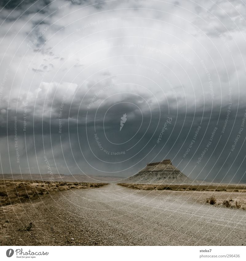 Highway 24 Storm clouds Bad weather Rain Thunder and lightning Rock Mountain Desert Gravel road Brown Gray Loneliness Apocalyptic sentiment Far-off places Utah