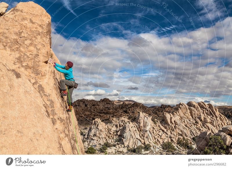 Female rock climber. Adventure Climbing Mountaineering Young woman Youth (Young adults) Clouds Self-confident Brave Determination Effort Ascent Balance