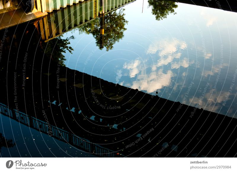 Oberhafen Neukölln Channel Harbour Water Surface of water Reflection Bridge Sky Heaven Clouds sheet pile wall Navigation Deserted Copy Space Summer Town