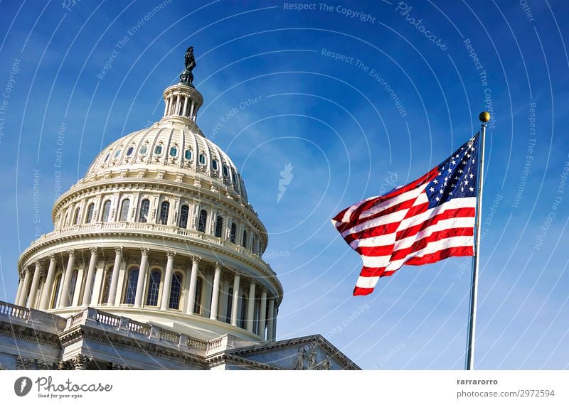 American flag waving with the Capitol Hill Vacation & Travel Tourism Sky Architecture Facade Monument Stripe Flag Historic Blue White Politics and state USA