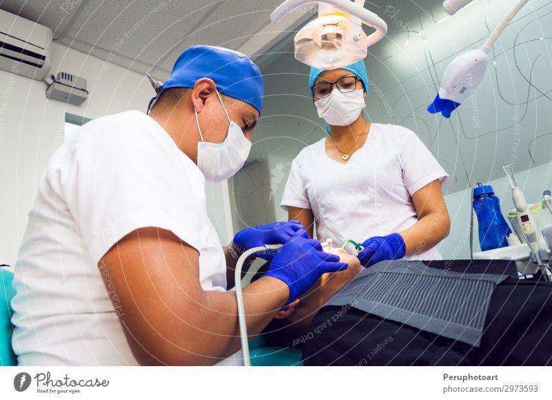 Dentist and his assistant doing a thorough examination of a patient Lifestyle Happy Health care Medication Examinations and Tests Work and employment Profession