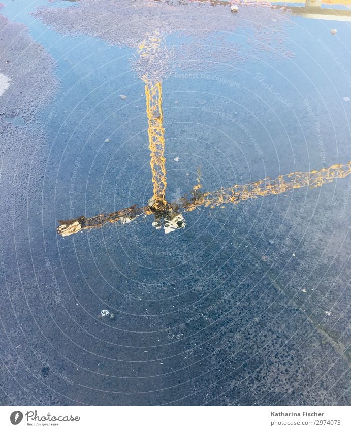 Water mirroring construction crane Blue Brown Yellow Gold Gray Orange Black Turquoise White Reflection Construction crane Puddle Street Colour photo