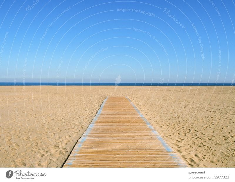 A yellow-blue picture, where the blue half is sky and the yellow half is sand and a wooden path on it. A thin dark blue line of sea in the middle Sun Beach