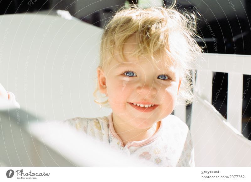 Portrait of a smiling baby girl in her cot Joy Bed Child Human being Feminine Baby Girl Infancy 1 0 - 12 months Blonde Smiling Happiness Daughter baby blond