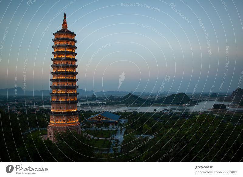 Evening view of illuminated Bai Dinh Pagoda and green landscape. Religious complex in Ninh Binh, Vietnam Exotic Vacation & Travel Tourism Sightseeing Culture