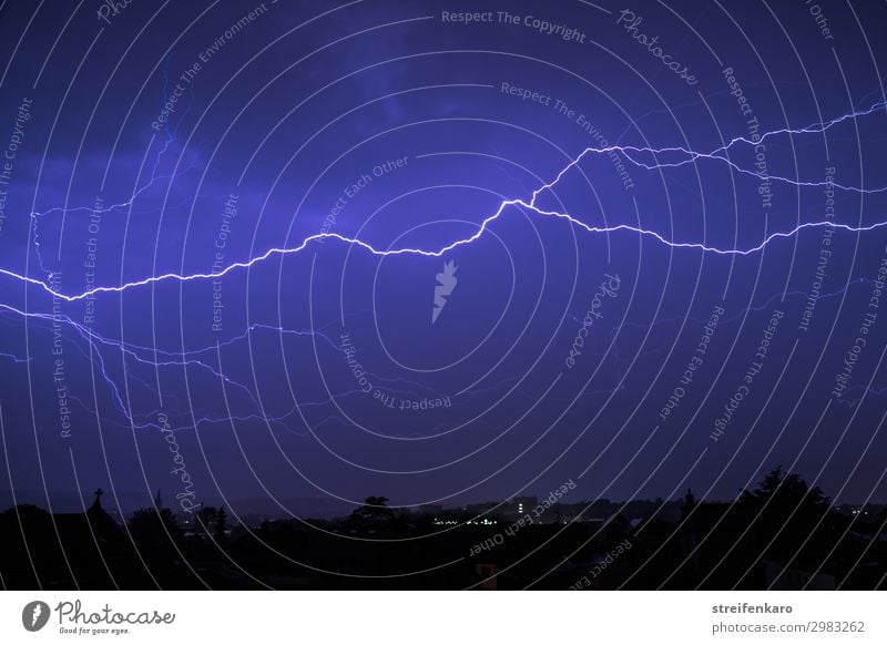 Flash in blue night sky over city silhouette Environment Nature Elements Air Sky Storm clouds Night sky Spring Climate Bad weather Gale Rain