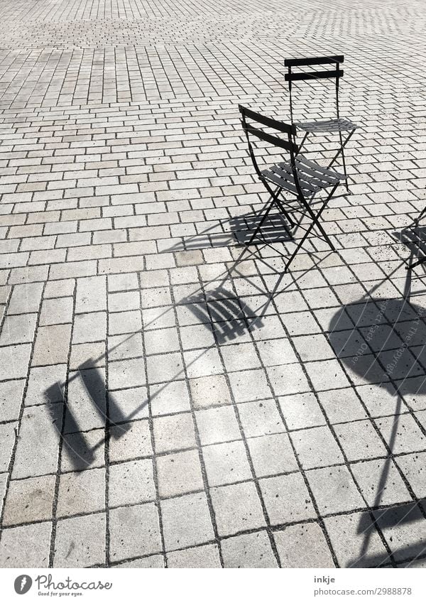 Prague street café Deserted Places Marketplace Folding chair Chair Line Gray Black Shadow Sidewalk café Paving stone Pave Colour photo Black & white photo