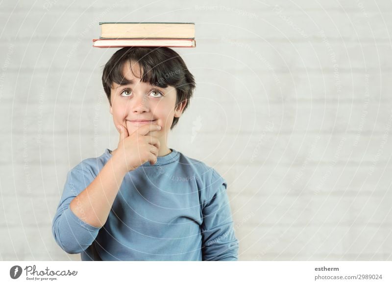 happy and smiling child with books on head Lifestyle Joy Playing Reading Child School Schoolchild Human being Masculine Infancy 1 8 - 13 years Book Observe