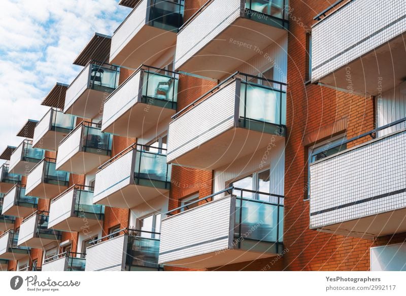 Apartment building with balconies and orange brick walls Style Vacation & Travel Tourism Beautiful weather Town Building Architecture Facade Balcony Modern