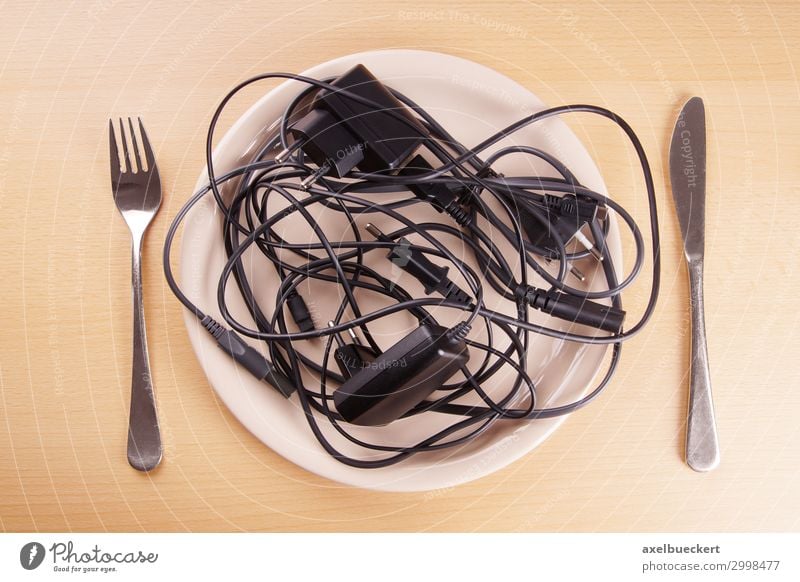 tangled cables Table Funny Chaos Whimsical Surrealism Humor Terminal connector Cable charger cable Plate Cutlery Technology Aggravation Eating Diet Muddled Knot