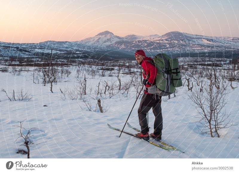 Winter adventurer in evening mood in front of mountain scenery Contentment Vacation & Travel Adventure Snow Winter vacation Winter sports Young man