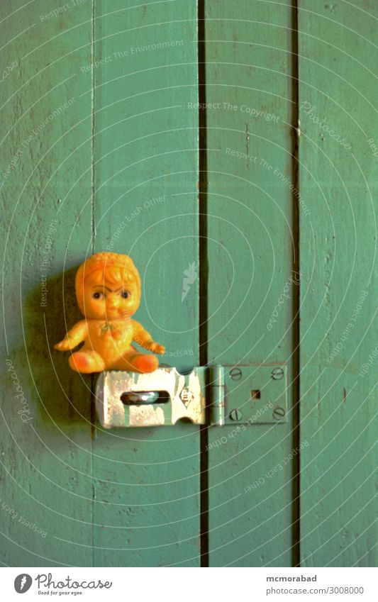 Sentry on Door Latch Toys Doll Small Funny Green Orange sentry guard sentinel Patrol door fastener humourous humorous amusing Comic Vertical Colour photo