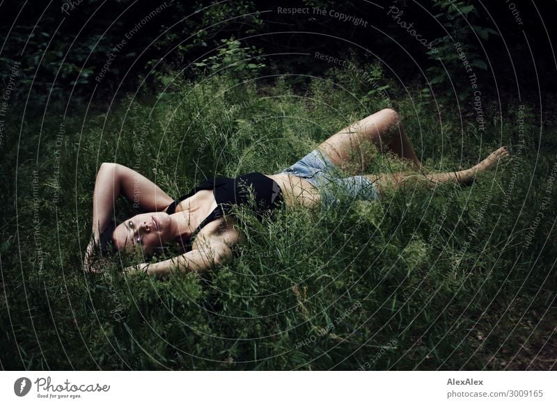 Portrait of a tall young woman lying in deep grass Lifestyle Joy luck already Well-being Senses Young woman Youth (Young adults) 18 - 30 years Adults Nature