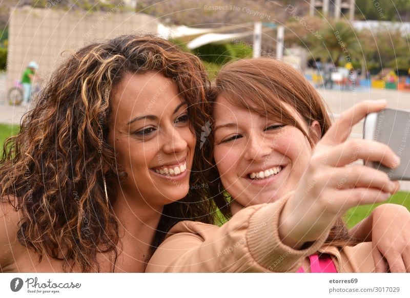 Two joyful cheerful girls taking a selfie in the street Selfie Young woman Girl Joy Friendliness Cheerful Happy Funny Woman Photography Smiling Mobile City