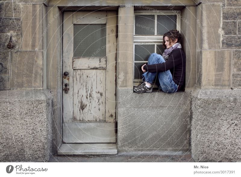 windows Feminine Woman Adults 1 Human being Sit Wait Door Window Window board View from a window Emotions Sadness Dream Facade Building Wooden door Longing